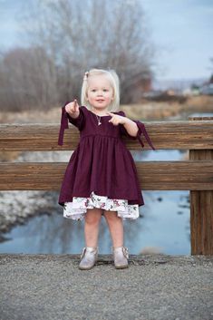 This burgundy colored linen and cotton layered dress is perfect for your little girl! It is perfect for both formal occasions, such as holidays or parties, or casual occasions, like going to a lake! The neckline is rounded and cute wooden buttons enclose the back. The sleeves are three-quarter length, though I can make them elbow length, having them tie at the end in an adorable fashion. The top layer of the dress is linen, whilst the bottom layer is a floral cotton that falls several inches bel Burgundy Cotton Dress For Spring, Spring Burgundy Cotton Dress, Girls Orange Dress, Layered Dresses, Pooh Dress, Floral Cotton Dress, Layered Dress, Flowing Skirt, Layer Dress