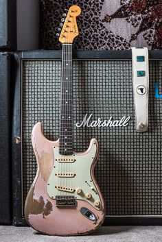 an electric guitar sitting on top of a amplifier