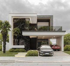 a car is parked in front of a modern house