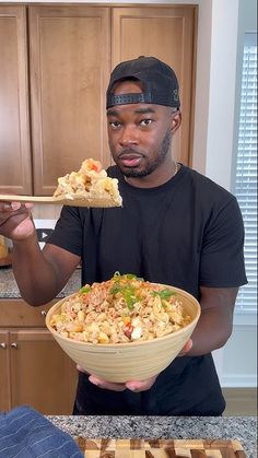 a man holding a bowl of food in his hands