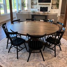 a dining room table with six chairs around it