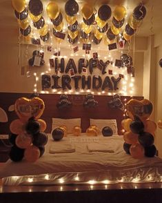 a bedroom decorated for a birthday with balloons and streamers