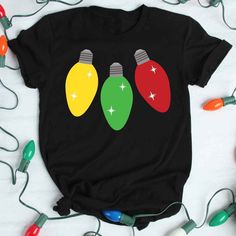 three christmas lights on a black t - shirt with green and red bulbs in the middle