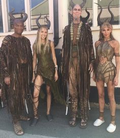 four people dressed in costumes standing next to each other