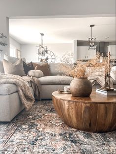 a living room filled with furniture and pillows on top of a wooden table in front of a couch