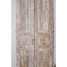 an old wooden door is open in the room