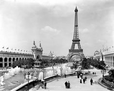 the eiffel tower towering over an old city with fountains and people walking around