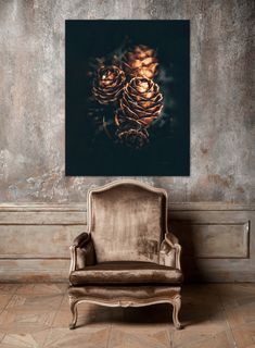 a chair sitting in front of a wall with a pine cone on it's back