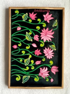 a painting with pink flowers and green leaves on a black background, framed in wooden frame