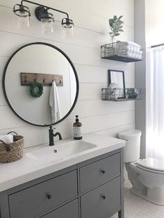 a bathroom with a toilet, sink and mirror in it's centerpieces