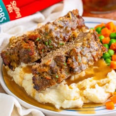 meatloaf, mashed potatoes and carrots on a plate with gravy