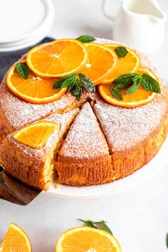 an orange cake with slices cut out on a plate