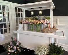 flowers in vases are sitting on a shelf