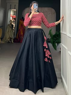 Upgrade your traditional wardrobe with this wonderful black cotton navratri lehenga with a printed crop top from Ethnic Plus. Crafted from high-quality cotton material, this set features a black color plain lehenga and a maroon crop top with digital printed work. The black lehenga is fully stitched up to 42 inches, offering a comfortable fit for various body types. With a 3.40-meter flair and a 41-inch length, it showcases elegance and grace. The crop top, also stitched to perfection, fits up to Crop Top Lehenga From Silk Saree, Crop Top Lehenga For Navratri, Black Blouse Navratri Outfit, Crop Tops For Sarees, Crop Top Lehenga Blouse Designs, Unique Navratri Outfits Ideas, Plain Skirt And Crop Top Indian, Indian Crop Top Designs, Black Crop Top Lehenga