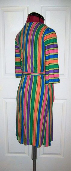 "Vintage 1960s Ladies Multi Color Striped Dress a Mary Muffett Original Small Bust =32\" 3/4 Sleeves, Back Zipper, Tie Belt, Mod Good Vintage Condition* Only $300 Waist =30\" Hips =34\" Shoulder to Shoulder =14 1/2\" Back Collar to Hem =37\" Sleeves Shoulder to Cuff =15\" *Small Hole on Shoulder, No Other Flaws -See Photos Note: This is the ONLY Known surviving Example of a Mary Muffet Dress with Label from the 1960s, there may be more stashed away in someone's closet, but currently no others se Garment Industry, Flowy Tops, Color Stripes, Vintage 1960s, Tie Belt, Small Bust, Short Sleeve Blouse, Shoulder Sleeve, Striped Dress