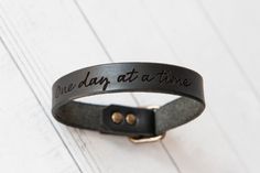 One Day At A Time Bracelet. Sobriety - Next Chapter - Affirmations - Personalized gift for him. Present for her. Just for you! These classic leather bracelets are comfortable to wear and just get better with age made from beautiful full grain vegetable tanned leather and solid brass hardware. Create a piece that carries those special words with you or for that special someone. How to order: —> Select your leather color. Options in photos. —> Select the engraving option. —> Bracelet fits up to a Affirmation Bracelets, Present For Her, Special Words, One Day At A Time, Presents For Her, Eggplant Purple, Leather Bracelets, Personalized Gifts For Her, Aging Beautifully