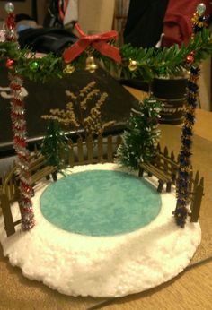 a cake that looks like it is made to look like a fence and snow covered pond