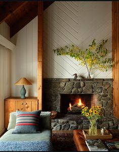 a living room filled with furniture and a fire place next to a wall mounted fireplace