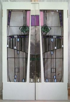 two white doors with stained glass panels on them