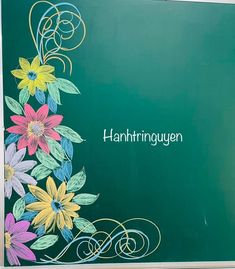 a green board with flowers painted on it