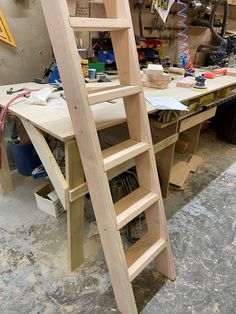 a wooden ladder sitting on top of a workbench