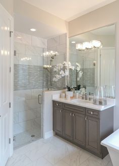 a bathroom with two sinks and a shower