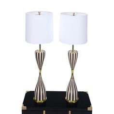 two lamps sitting on top of a black box