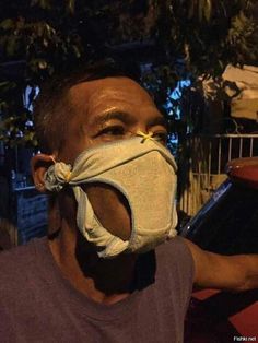 a man wearing a face mask while sitting at a table