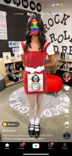 a woman in a red dress and white socks is holding a book bag while wearing headphones