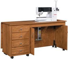 a sewing machine sitting on top of a wooden desk next to a drawer with drawers