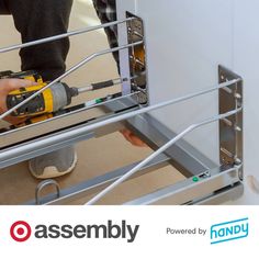 a man using a drill machine to attach a metal frame on a wall with the words assembly powered by handy