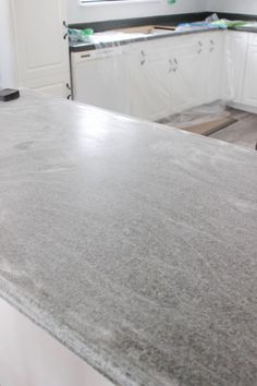 a counter top in a kitchen with white cabinets