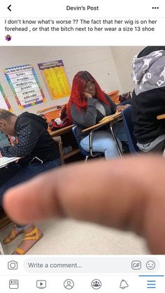 a person taking a selfie in front of a class room with other people sitting at their desks