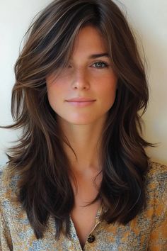 Woman with layered brown hair and freckles, wearing a patterned top, smiling lightly. Layered Hair With Face Frame, Medium Length Hair With Heavy Layers, Layered Hair Medium With Curtain Bangs, Medium Length With Face Framing, Middle Length Layered Haircut, Face Framing For Long Hair, Layers And Face Framing Medium Hair, Brown Medium Haircut, Medium Length Haircut For Thick Hair With Layers Bangs