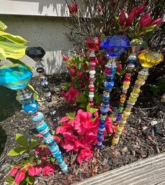 there are many colorful glass vases in the garden