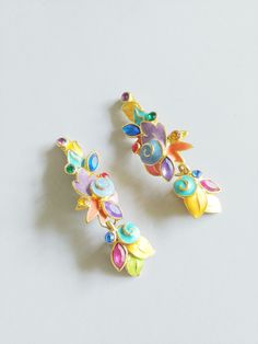 "1980s tropical leaves drop earrings ~Irridescent green, blue, orange, purple, and yellow enamel painted metal with rhinestone accents ~Metal clip on backs ~Signed E B(Engel Brothers) Condition: Excellent Drop pieces measure 2\" x 1\" Posts measure 7/8\" x .75\" Message us with any questions! Sarah Vogt" Multicolor Enamel Earrings For Party, Cooling Scarf, Beauty Shop, Romantic Style, Metallic Paint, Costumes For Women, Vintage Earrings, Costume Jewelry, Cute Jewelry