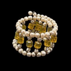 "This fabulous vintage coil wrap bracelet is made by Miriam Haskell. This is likely from the 1930's. It has the beautiful soft creamy white small baroque glass pearls with fun hexagon (6 sided) golden color glass beads for the centers. Made in the time frame of smaller bodies and wrists, so this would fit best a 5-6\" wrist.  It is in very good condition for the age. No visible wear to the finish of the pearls. This is not signed, but attributed to Haskell by way of construction, materials, and style." Wrap Armband, Wire Wrap Bracelet, Vintage Rhinestone Jewelry, Wire Wrapped Bracelet, Miriam Haskell, Cool Necklaces, Construction Materials, Golden Color, Wire Wrap