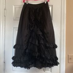 New With Tags Purchased In 2011 For A Halloween Costume Party And Never Wore It’s Been In Storage Ever Since Rq-Bl Red Queens Black Legion Polyester Multi Tier Skirt Pull On Style Elastic Waist High Low Hem Size F Will Fit One Size It’s All Size Small To Large Measurements Waist 12” Flat Across And 18” Max Stretched Length 29” Height 34” Low In Preowned Condition Black Long Ruffled Skirt Petticoat, Black Long Ruffled Petticoat, Ruffled Tiered Skirt For Costume Party, Black Costume Skirt With Attached Cancan, Black Skirt With Attached Cancan For Costume, Black Petticoat Skirt For Costume Party, Black Skirt Petticoat For Costume Party, Black Petticoat For Costume Party, Costume Black Skirt With Ruffles