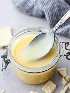 a spoon in a jar filled with butter