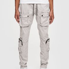 The Utility Pant is an 8 Pocket Versatile Do-It-All machine! You can wear these loose or tapered. Stretchy and comfortable it has the perfect fabric weight to be worn all year round. 97% Cotton + 3% Spandex 8 pockets Snap Button Adjustable Hem Size up for a loose fit Model is 6'2" 165lbs wearing size M. Survival Clothing, Youth Clothing, Utility Pants, Black Camo, Cargo Pants Men, Denim Overalls, Denim Coat, Romper Pants, Sweater And Shorts