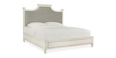 a white bed with an upholstered headboard and foot board on the side