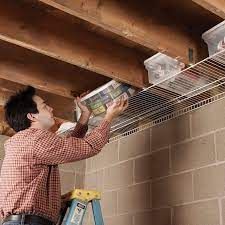 a man is working on the ceiling in his house