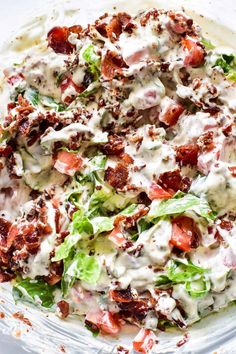 a salad with dressing in a glass bowl