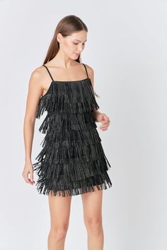 This Embellished Faux Suede Fringe Mini Dress is perfect for a night out on the town. With its sleeveless design, fringed detail, and embellished accents, this dress is sure to turn heads. Whether you're hitting up a club or going to a fancy dinner, this mini dress is a great choice. You'll look and feel fabulous in this amazing dress. Faux suede Adjustable straps Fringe detail torso Mini length Sleeveless Lined Hand wash cold Do not bleach Do not tumble dry Do not dry clean Do not iron Shell: 5 Glamorous Sleeveless Fringe Mini Dress, Party Mini Dress With Fringe, Knee-length, Spring Fringe Knee-length Mini Dress, Black Sleeveless Mini Dress With Fringe, Party Mini Dress With Fringe And V-neck, Suede Mini Dress, Fringe Mini Dress, Rhinestone Dress, Fancy Dinner