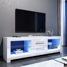 a white and blue entertainment center with a flat screen tv mounted on it's side