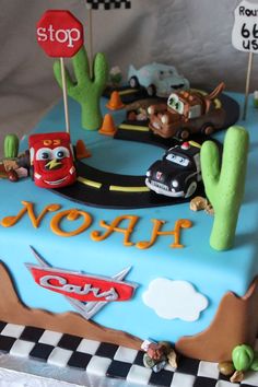 a birthday cake with cars on the road and stop sign