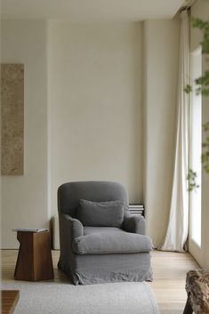 a living room with a chair and rug