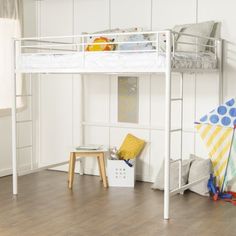 a white bunk bed sitting on top of a hard wood floor