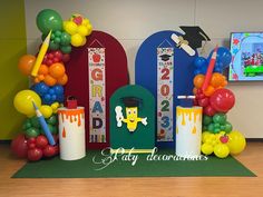 an entrance to a school decorated with balloons and decorations for the graduation ceremony is shown