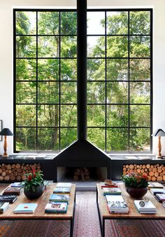 the living room is decorated in black and white, with wood stacked up against the wall